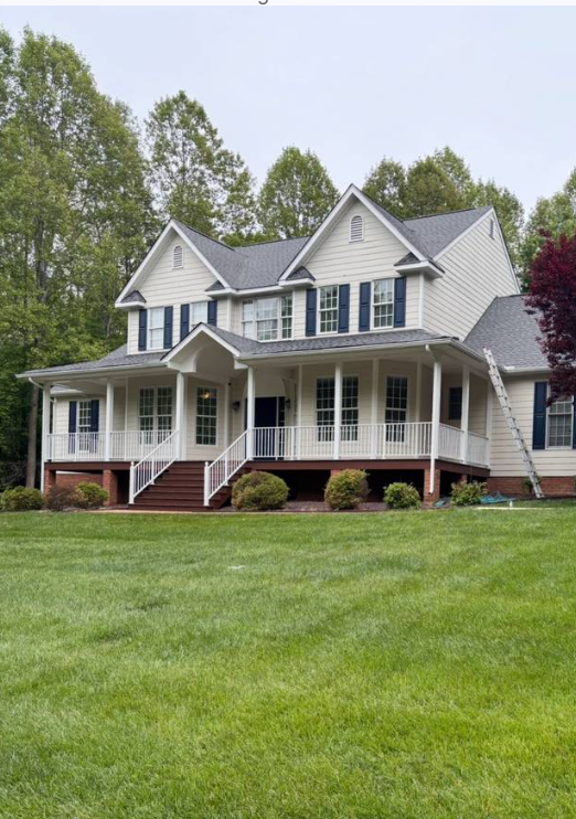 Two-story white farmhouse in Virginia with a freshly completed dark shingle roof and wrap-around porch