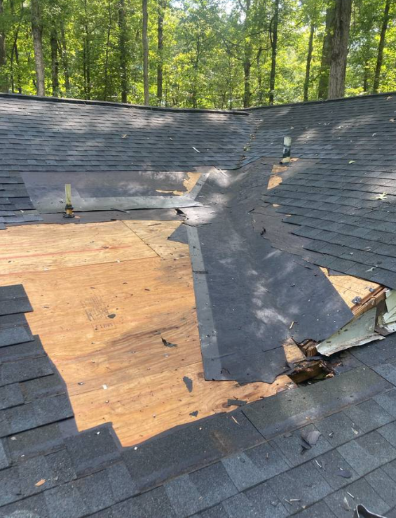 Section of an older roof being stripped to plywood for replacement