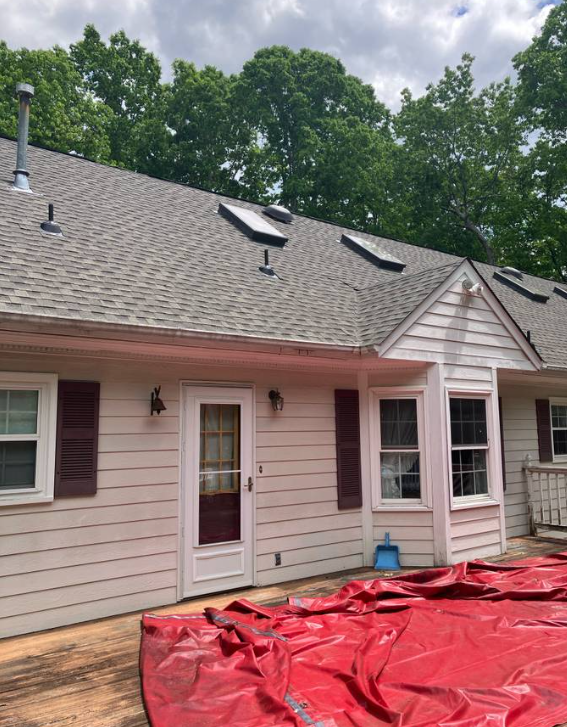 Completed shingle roof with skylights on a ranch home